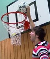 Basketball player dunking a ball